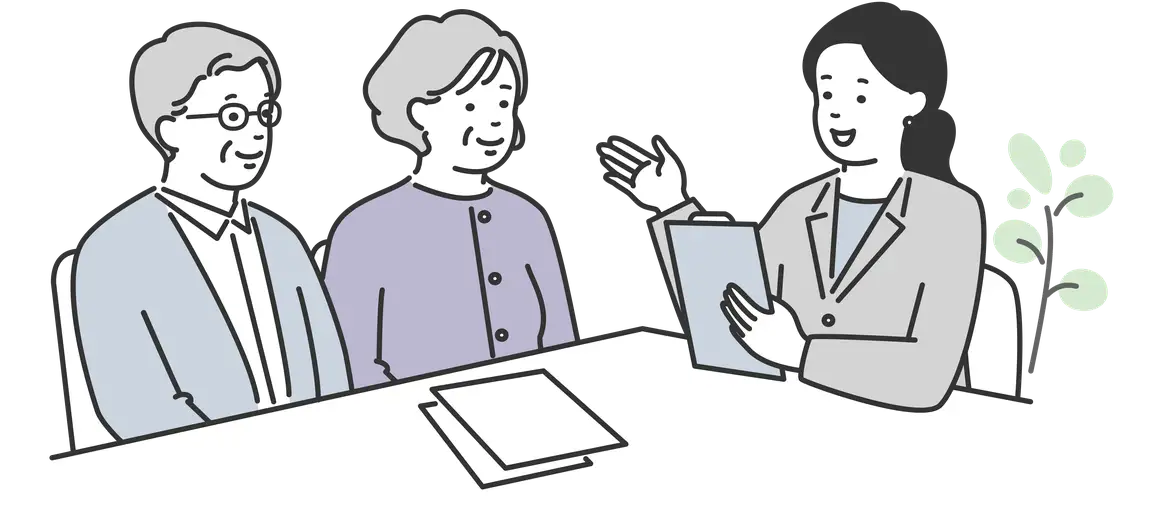 不動産相続について相談する高齢のご夫婦とスタッフ